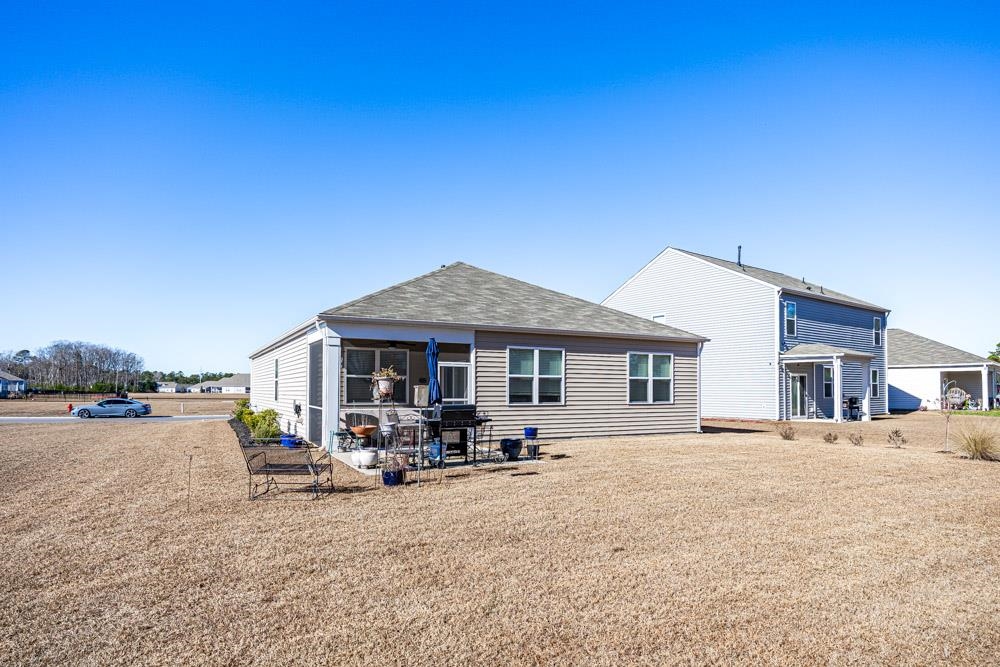2115 Ridgedale Drive Conway, SC 29526 - Photo 28 of 38 Rear view of property featuring a patio, a shingled roof, and a sunroom