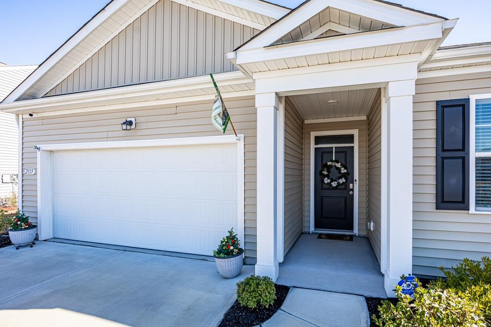 2115 Ridgedale Drive Conway, SC 29526 - Photo 30 of 38 Doorway to property with board and batten siding, concrete driveway, and a garage