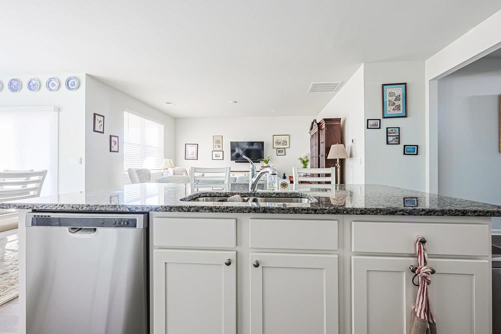 2115 Ridgedale Drive Conway, SC 29526 - Photo 38 of 38 Kitchen featuring white cabinets, dishwasher, dark stone counters, open floor plan, and a center island with sink