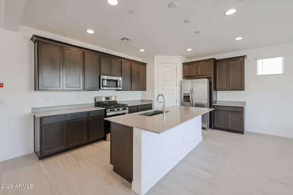 a large kitchen with stainless steel appliances lots of counter top space