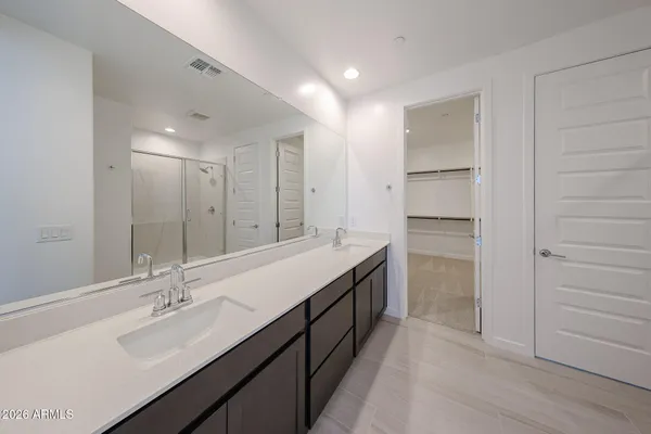 a bathroom with a double vanity sink and a mirror