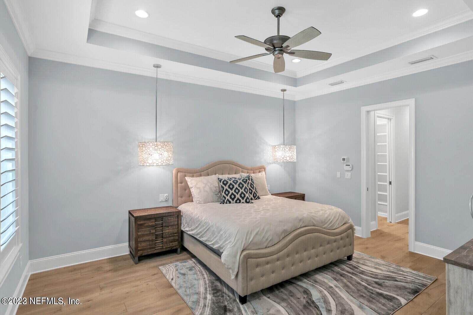 168 Hickory Hill Drive St. Augustine, FL 32095 - Photo 16 of 42 a bedroom with a large bed and a ceiling fan