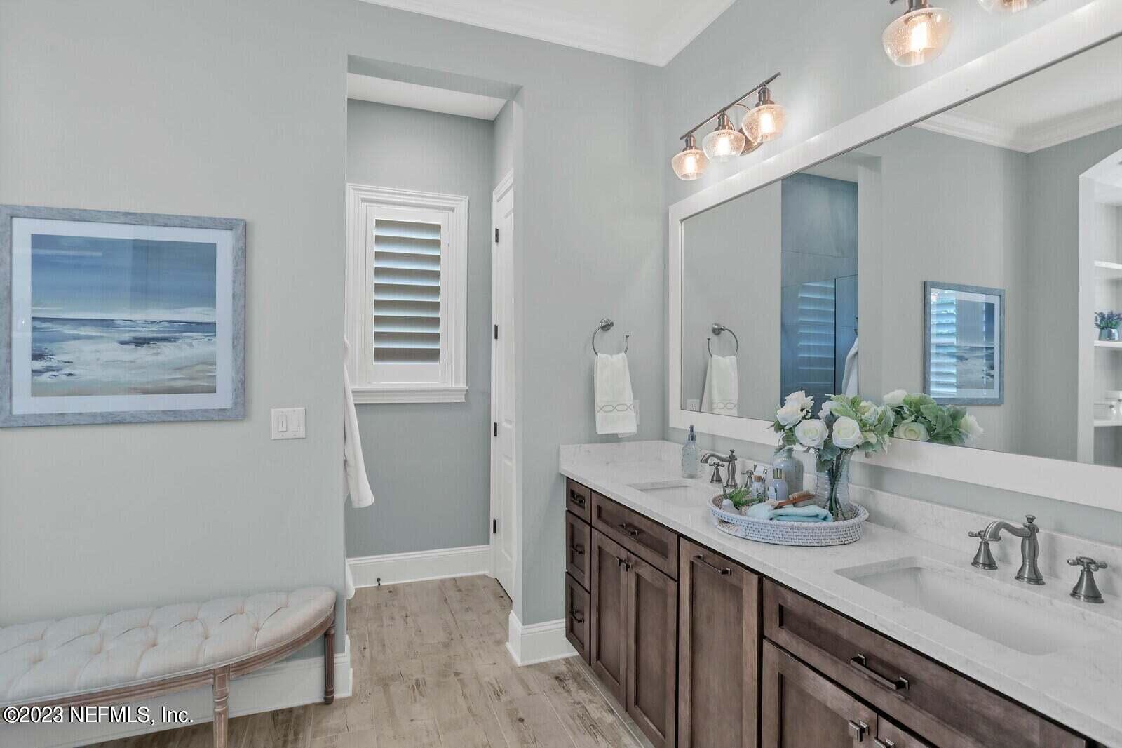 168 Hickory Hill Drive St. Augustine, FL 32095 - Photo 17 of 42 a bathroom with a double vanity sink and a mirror