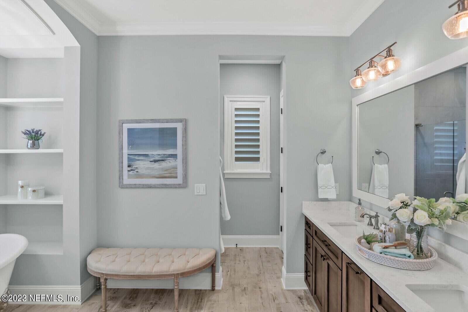 168 Hickory Hill Drive St. Augustine, FL 32095 - Photo 18 of 42 a bathroom with a toilet a sink and a large mirror