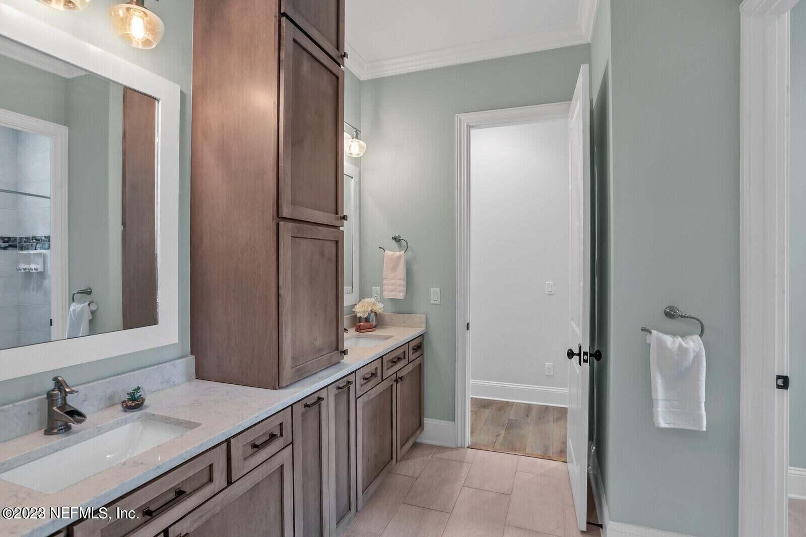 168 Hickory Hill Drive St. Augustine, FL 32095 - Photo 30 of 42 a bathroom with a double vanity sink and mirror with shower