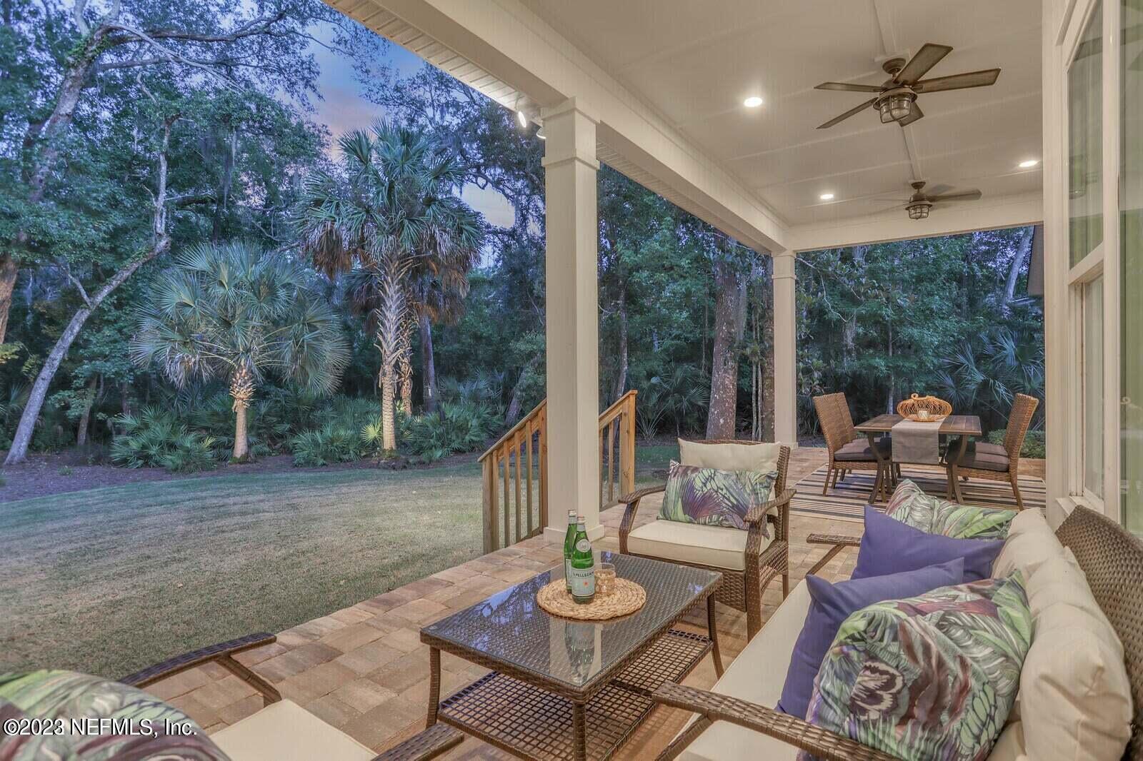 168 Hickory Hill Drive St. Augustine, FL 32095 - Photo 37 of 42 a living room with furniture and a floor to ceiling window