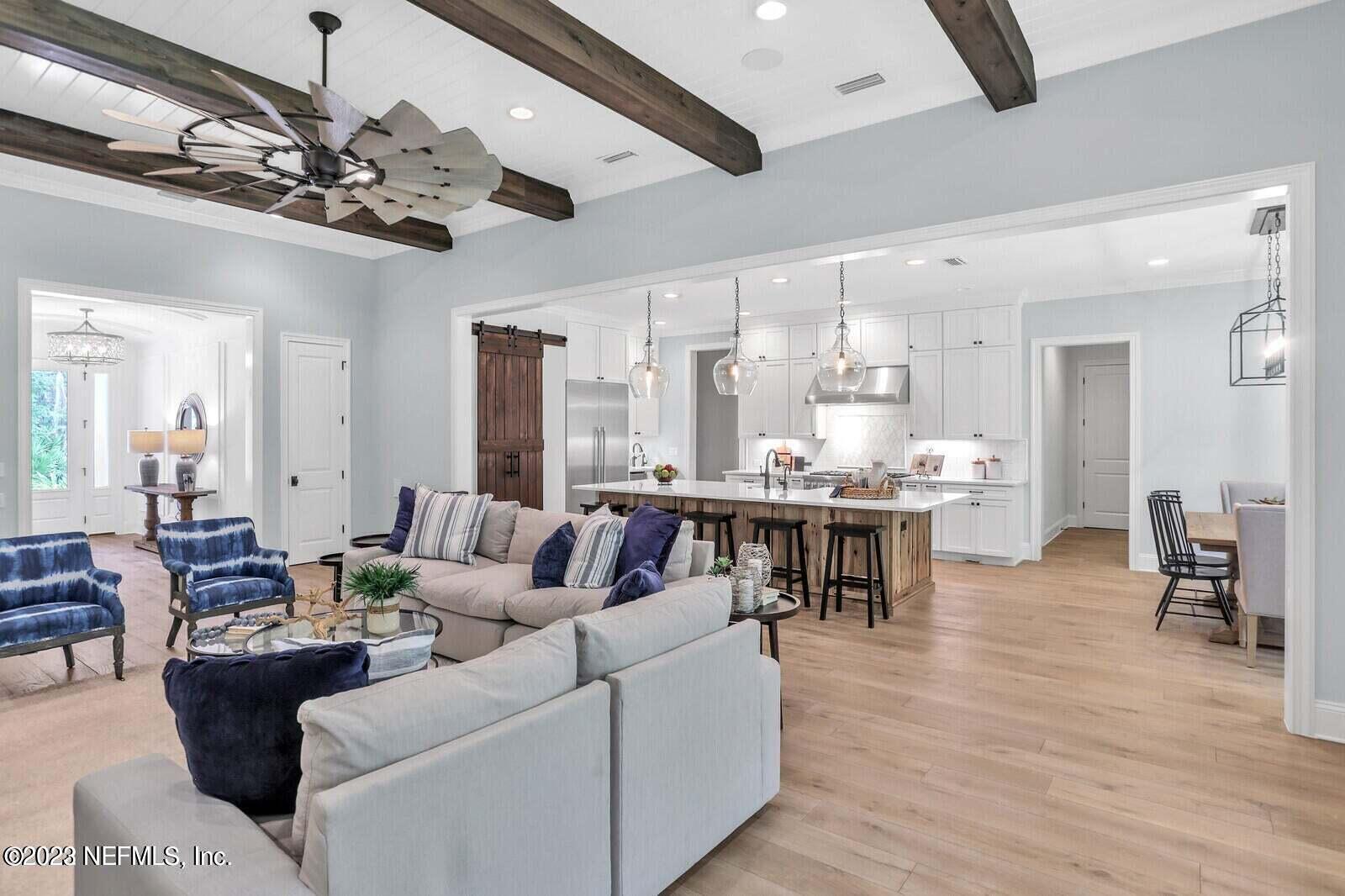 168 Hickory Hill Drive St. Augustine, FL 32095 - Photo 4 of 42 a living room with furniture kitchen view and a wooden floor