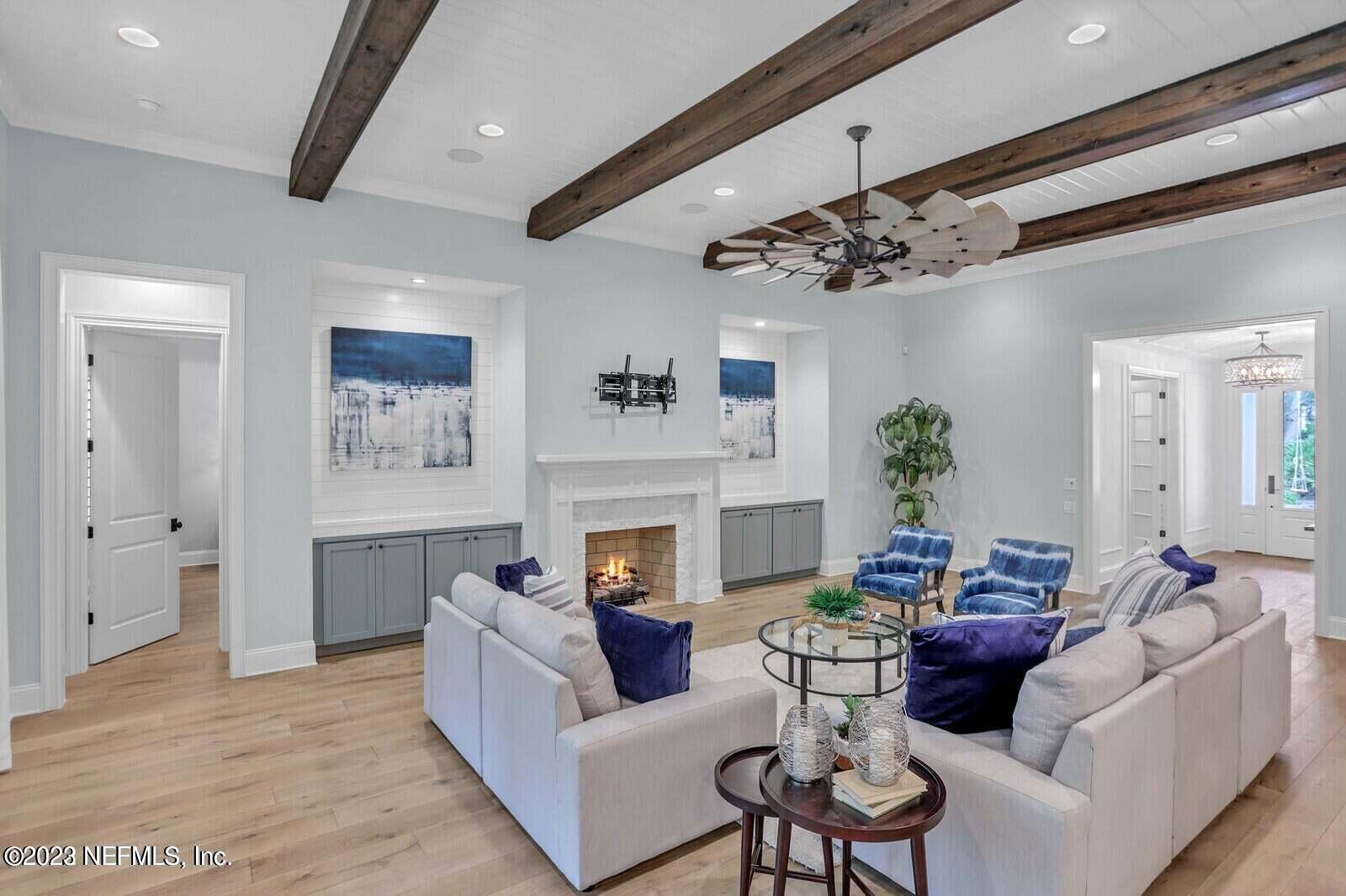 168 Hickory Hill Drive St. Augustine, FL 32095 - Photo 6 of 42 a living room with furniture a fireplace and a chandelier