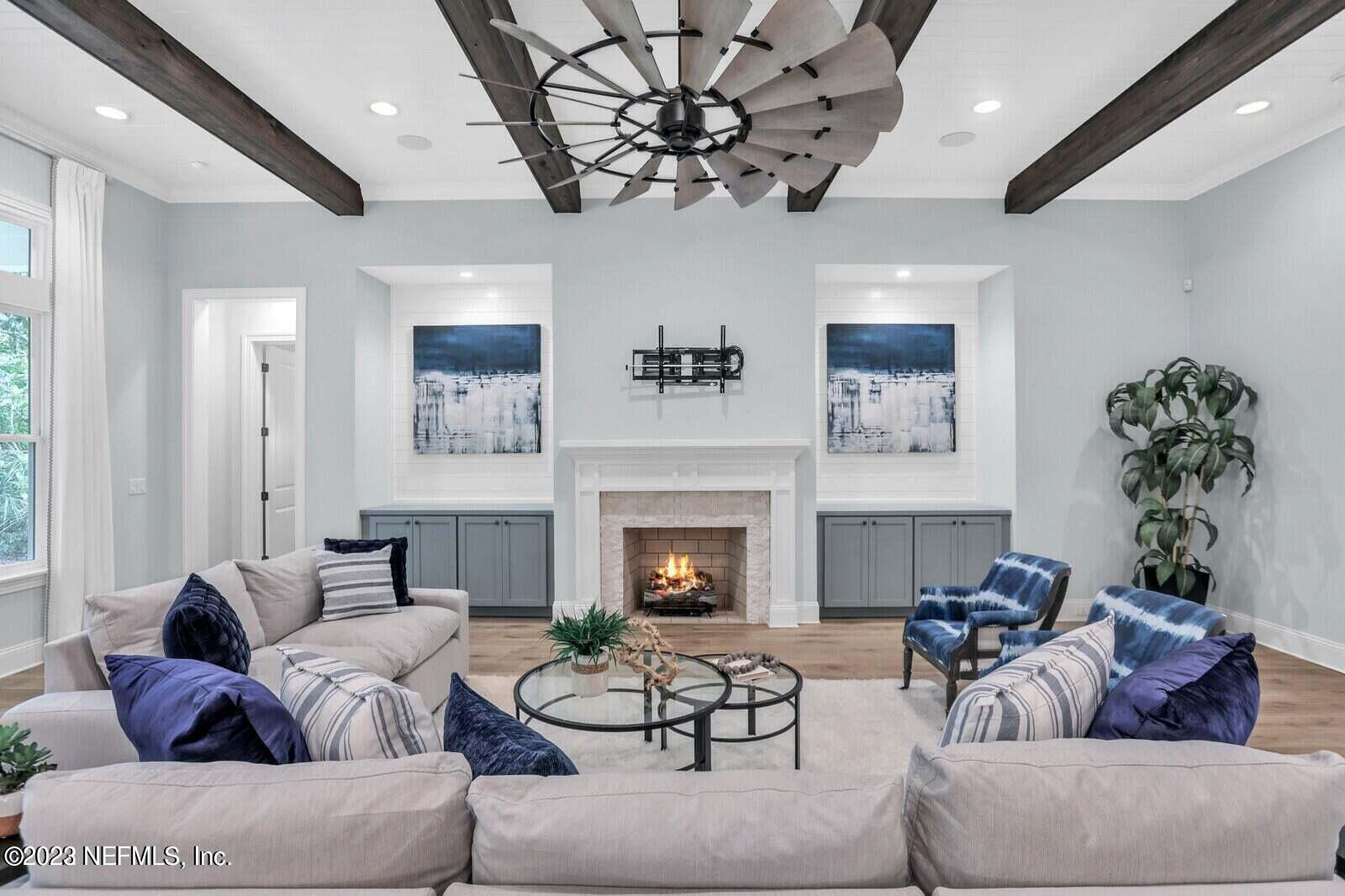 168 Hickory Hill Drive St. Augustine, FL 32095 - Photo 8 of 42 a living room with furniture a fireplace and a chandelier