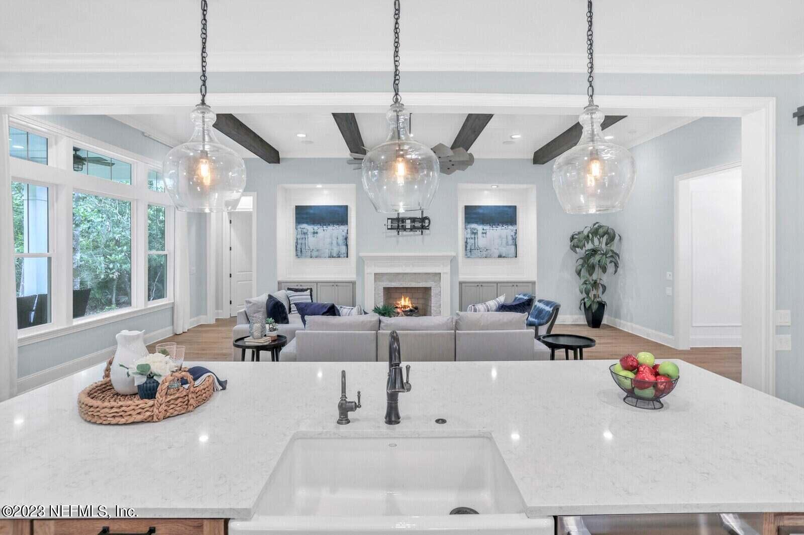 168 Hickory Hill Drive St. Augustine, FL 32095 - Photo 9 of 42 a view of a dining room with furniture a chandelier and large windows
