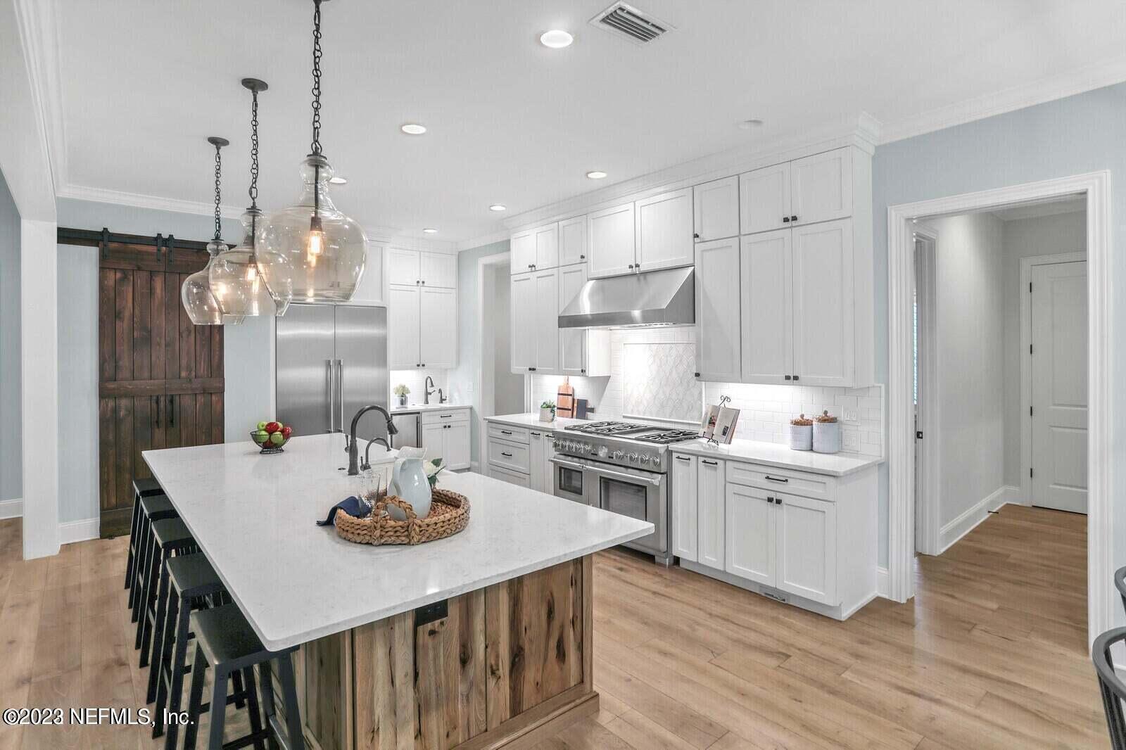 168 Hickory Hill Drive St. Augustine, FL 32095 - Photo 10 of 42 a kitchen with a dining table chairs stainless steel appliances and cabinets