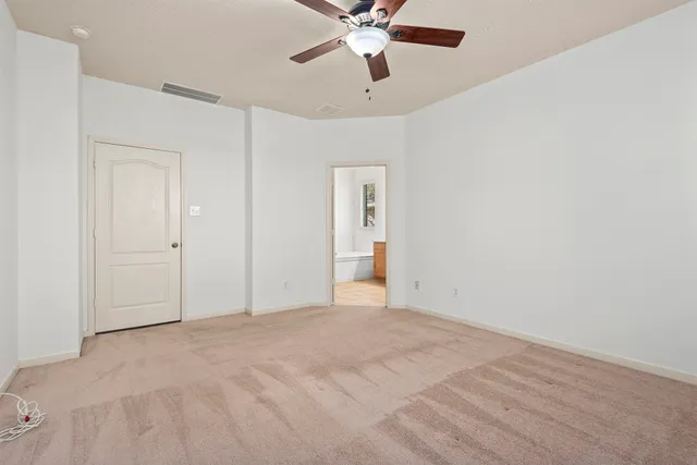 a bathroom with a granite countertop sink a toilet and a mirror