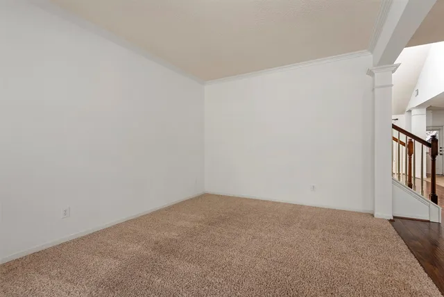 wooden floor fireplace and windows in an empty room