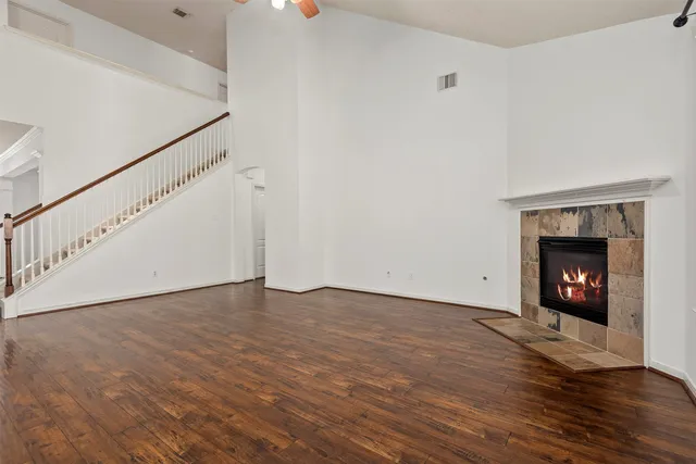 a kitchen with stainless steel appliances granite countertop a refrigerator oven a sink dishwasher and white cabinets next to a window