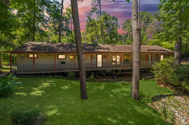a view of a house with backyard and sitting area