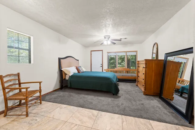 a bedroom with a bed and a television