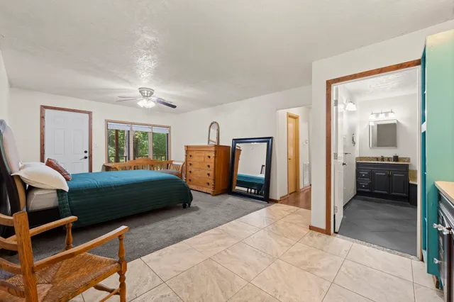 a bedroom with a bed and a view of living room