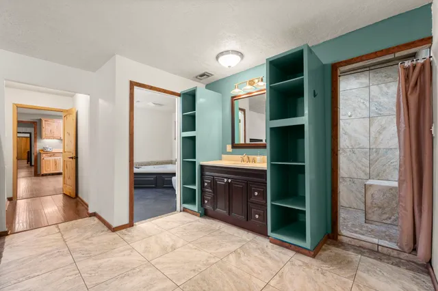 a spacious bathroom with a shower and a sink