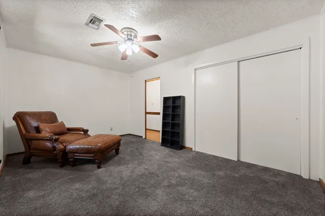 a living room with furniture and ceiling fan