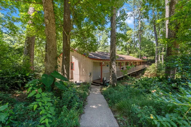 a pathway of a house with a yard