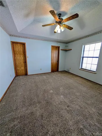 an empty room with closet and windows