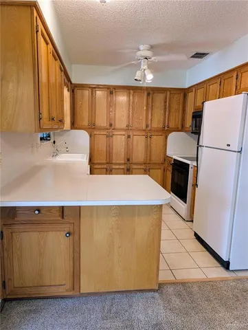 a kitchen with a refrigerator a sink dishwasher and a large refrigerator