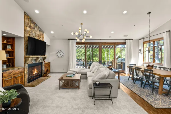 a living room with fireplace furniture and a flat screen tv