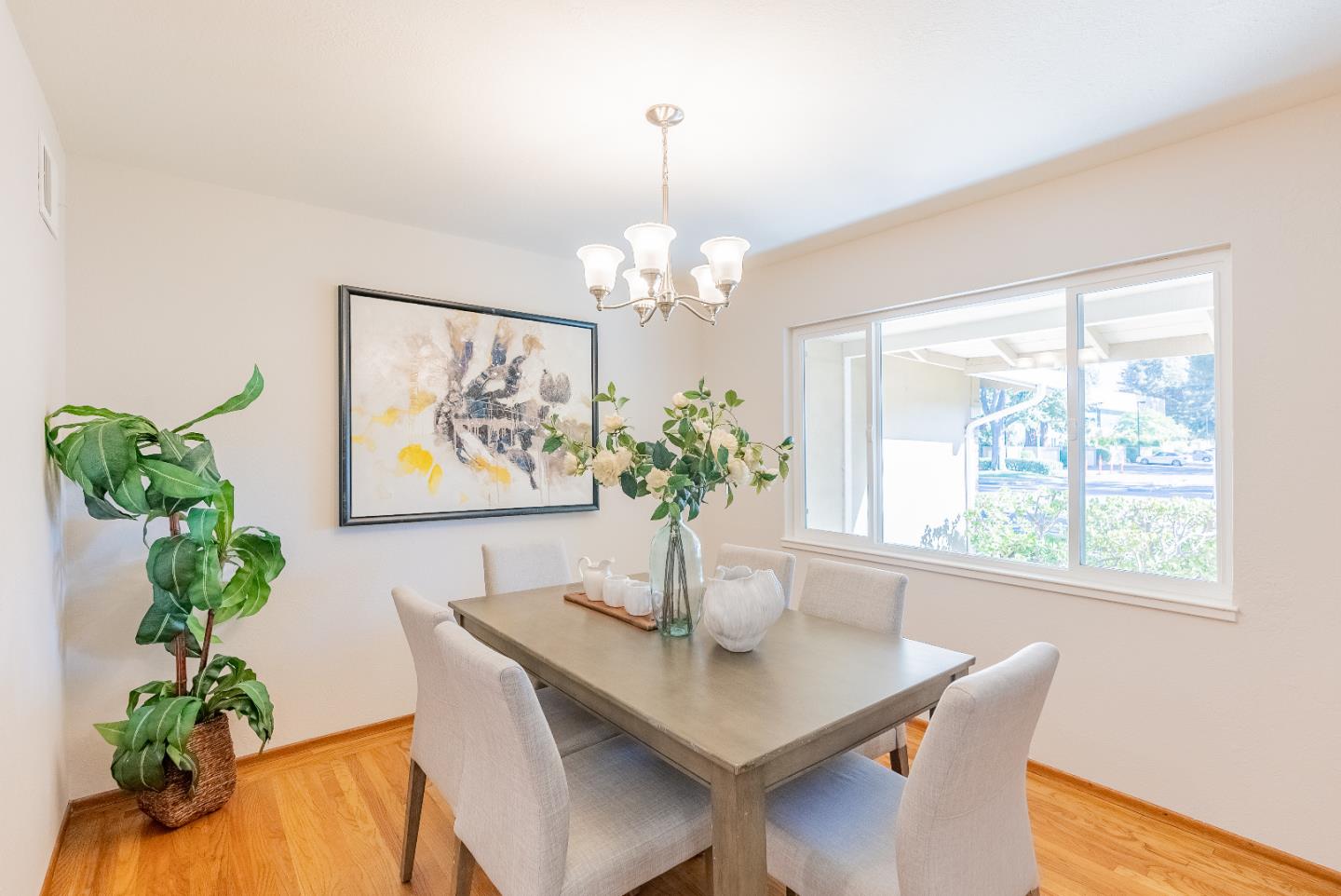 1069 East Homestead Road Sunnyvale, CA 94087 - Photo 11 of 36 a dining room with furniture a potted plant and a chandelier