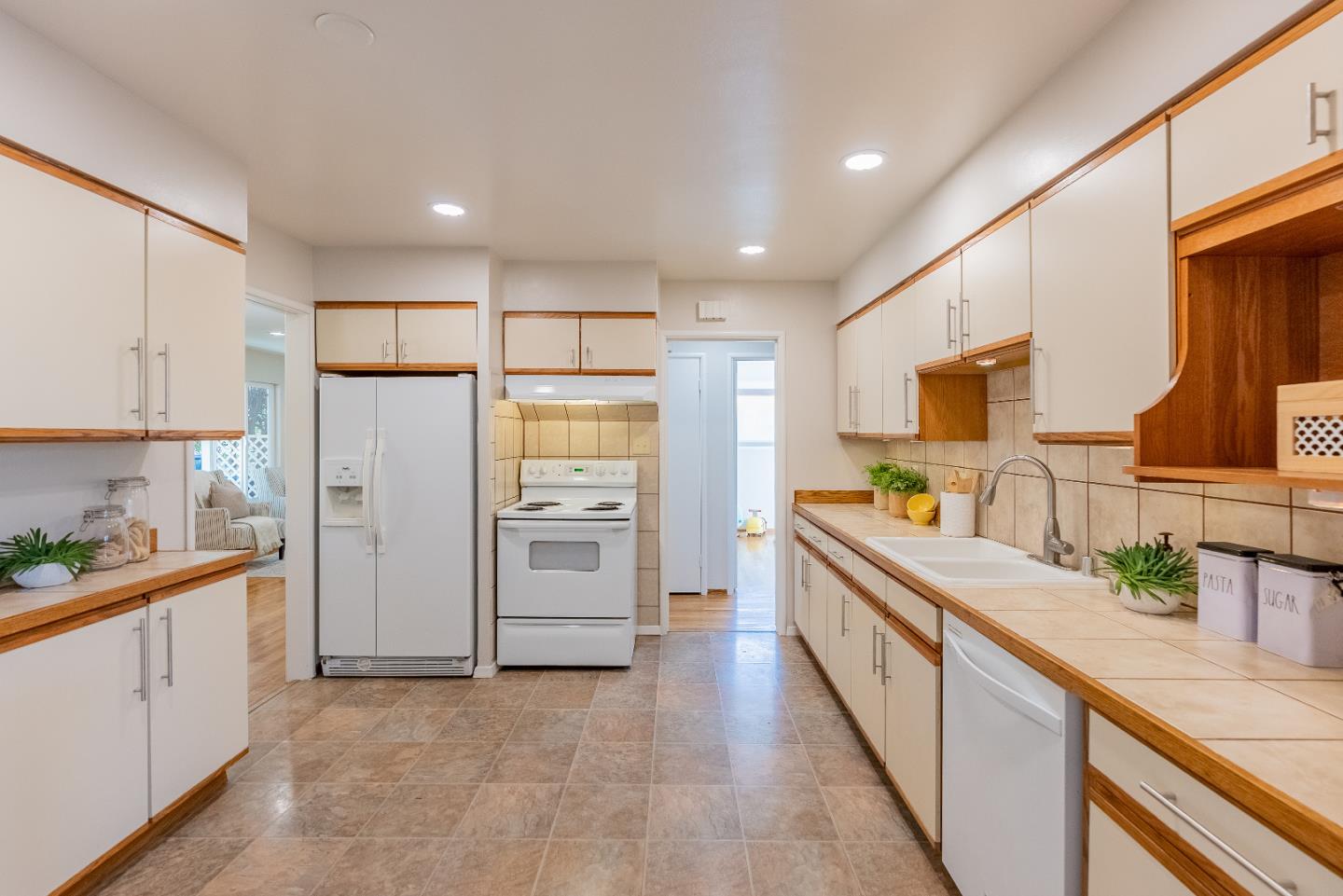 1069 East Homestead Road Sunnyvale, CA 94087 - Photo 12 of 36 a kitchen with stainless steel appliances a refrigerator sink and cabinets