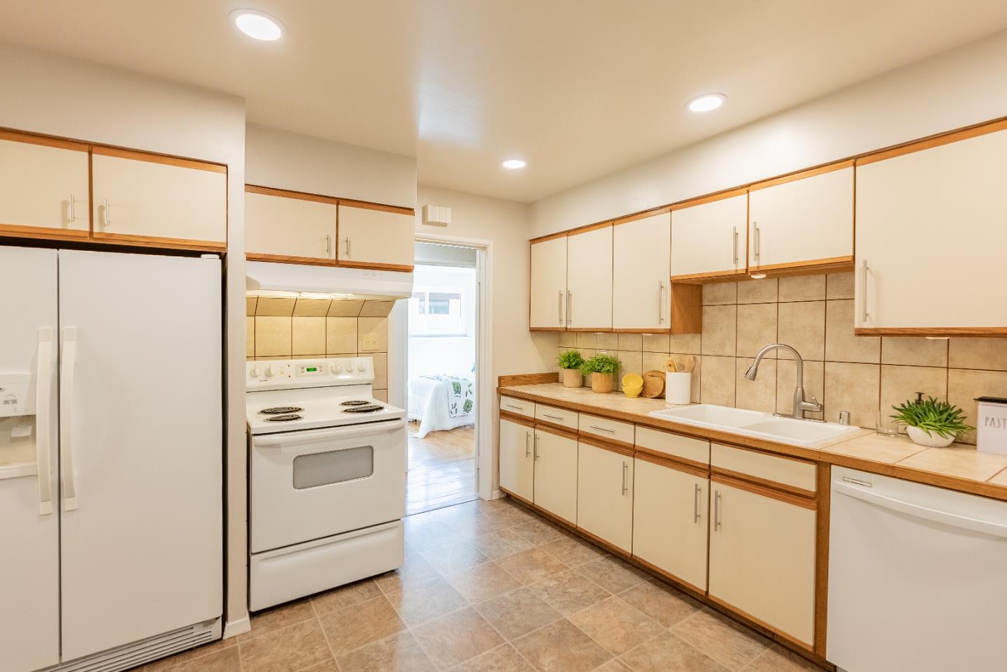 1069 East Homestead Road Sunnyvale, CA 94087 - Photo 14 of 36 a kitchen with stainless steel appliances a sink cabinets and a window