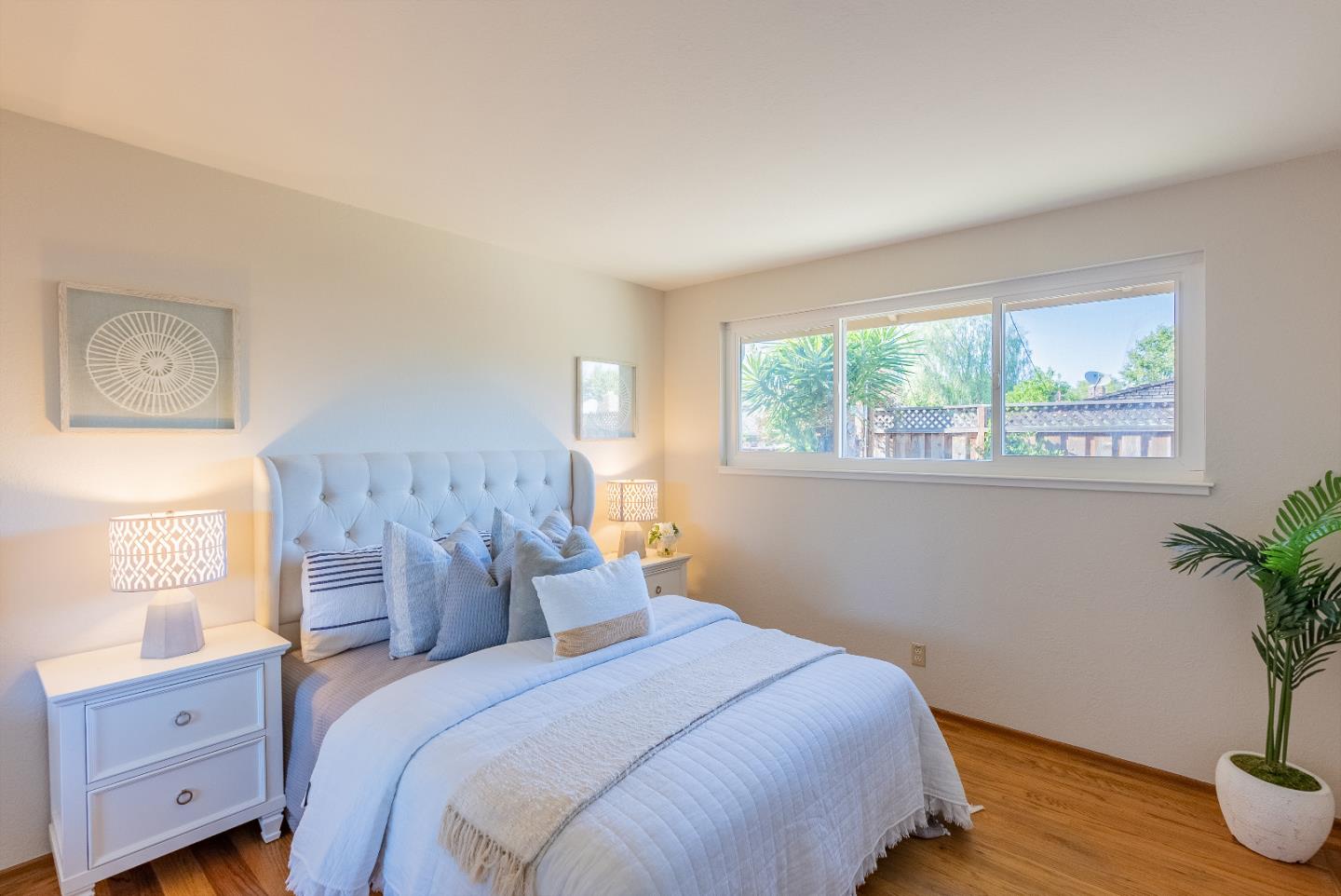1069 East Homestead Road Sunnyvale, CA 94087 - Photo 21 of 36 a bedroom with a bed and a potted plant