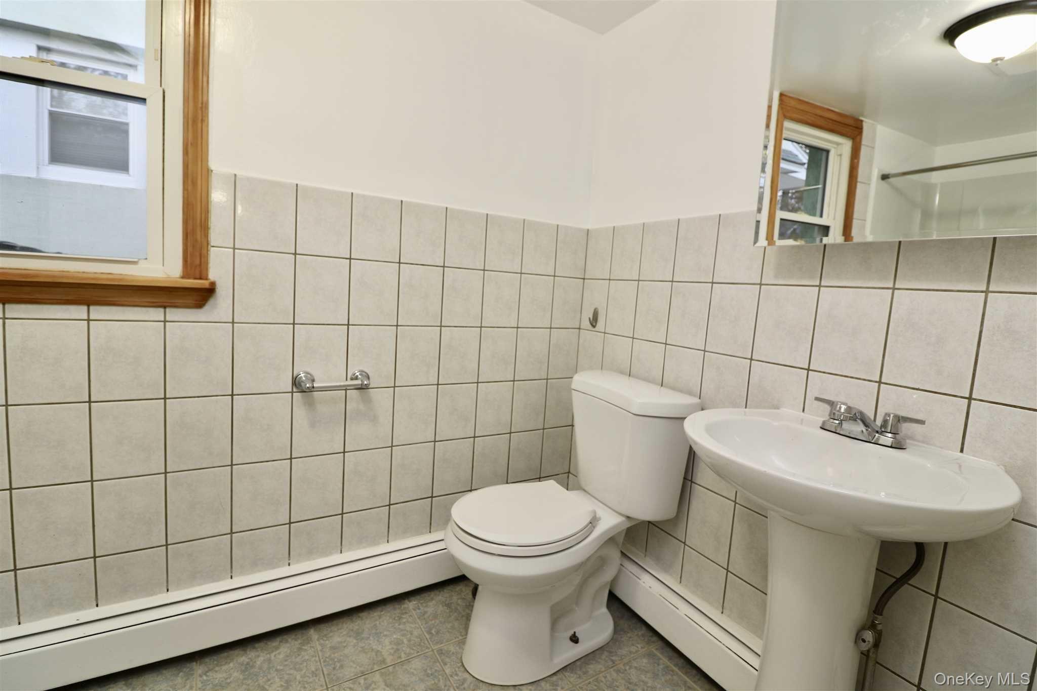 128 Catherine Street, Unit A Beacon, NY 12508 - Photo 17 of 18 a bathroom with a sink toilet and shower