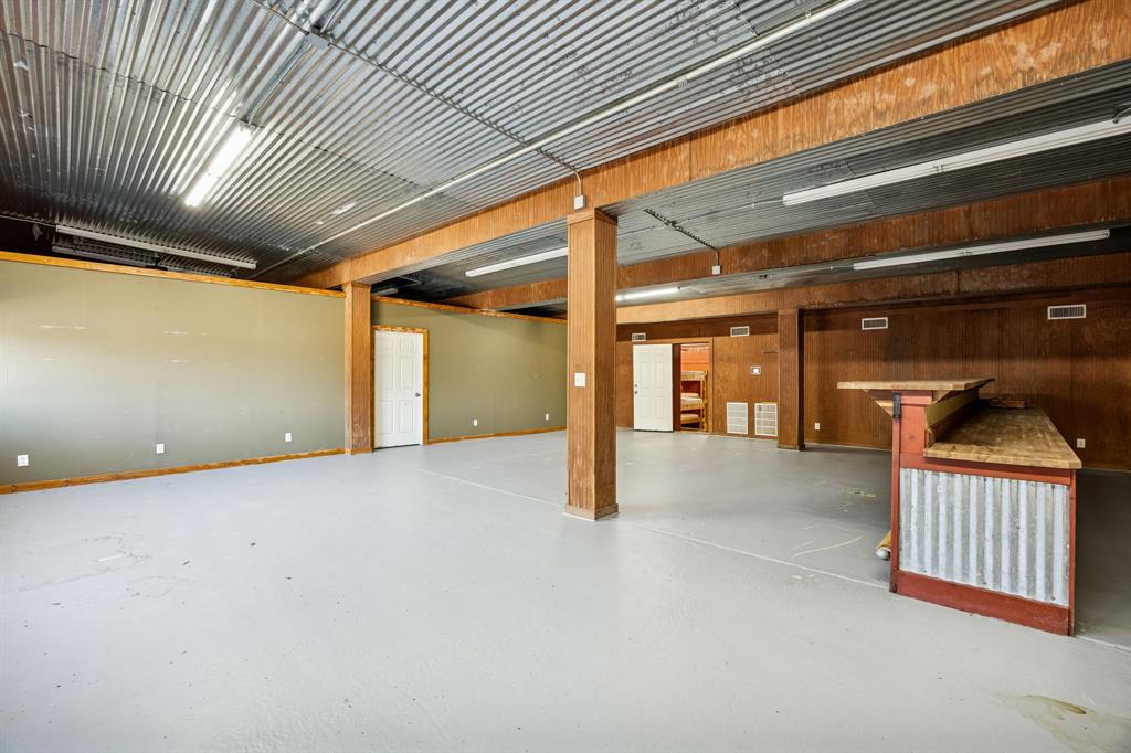 1922 A Bethel-Cannon Road Whitewright, TX 75491 - Photo 31 of 40 Expansive open space featuring a corrugated metal ceiling and light gray flooring