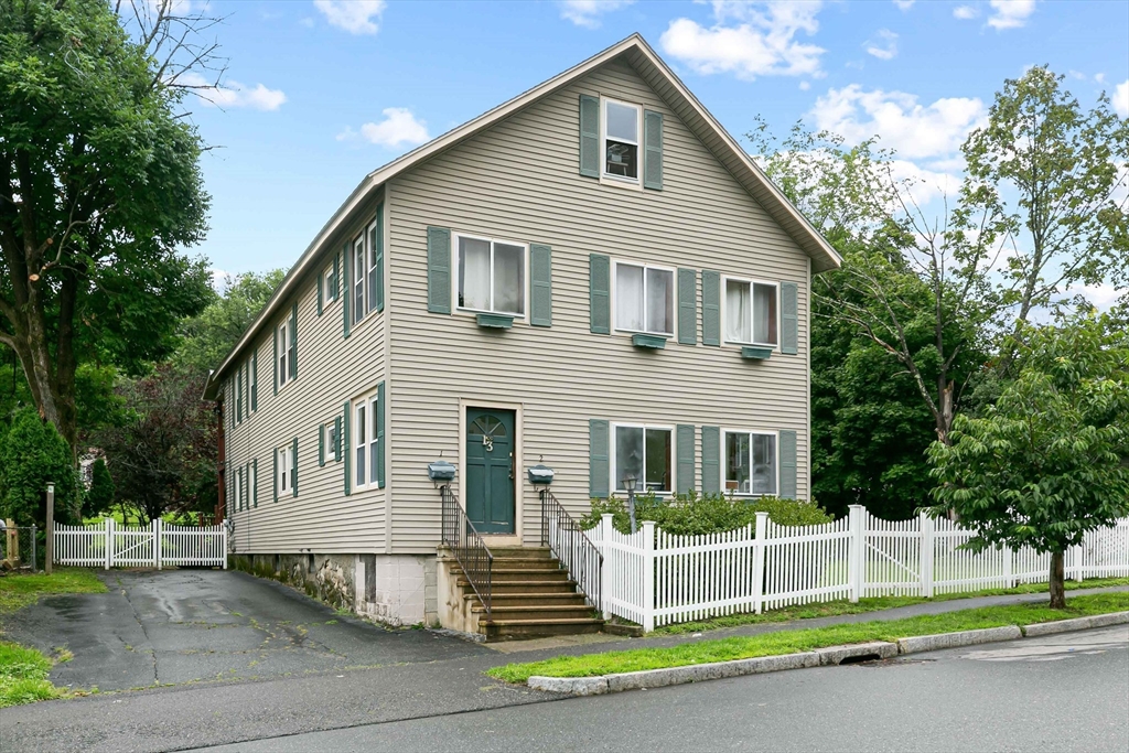 a view of house with a yard and fence