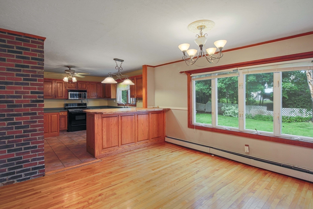 13 Superior Road Worcester, MA 01604 - Photo 15 of 40 a open kitchen with stainless steel appliances granite countertop a stove and cabinets with wooden floor