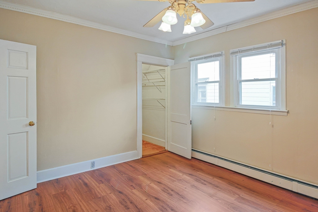 13 Superior Road Worcester, MA 01604 - Photo 17 of 40 an empty room with wooden floor chandelier and windows