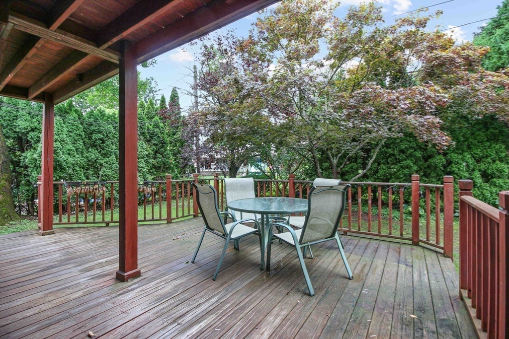 13 Superior Road Worcester, MA 01604 - Photo 23 of 40 a view of a deck with table and chairs and wooden floor