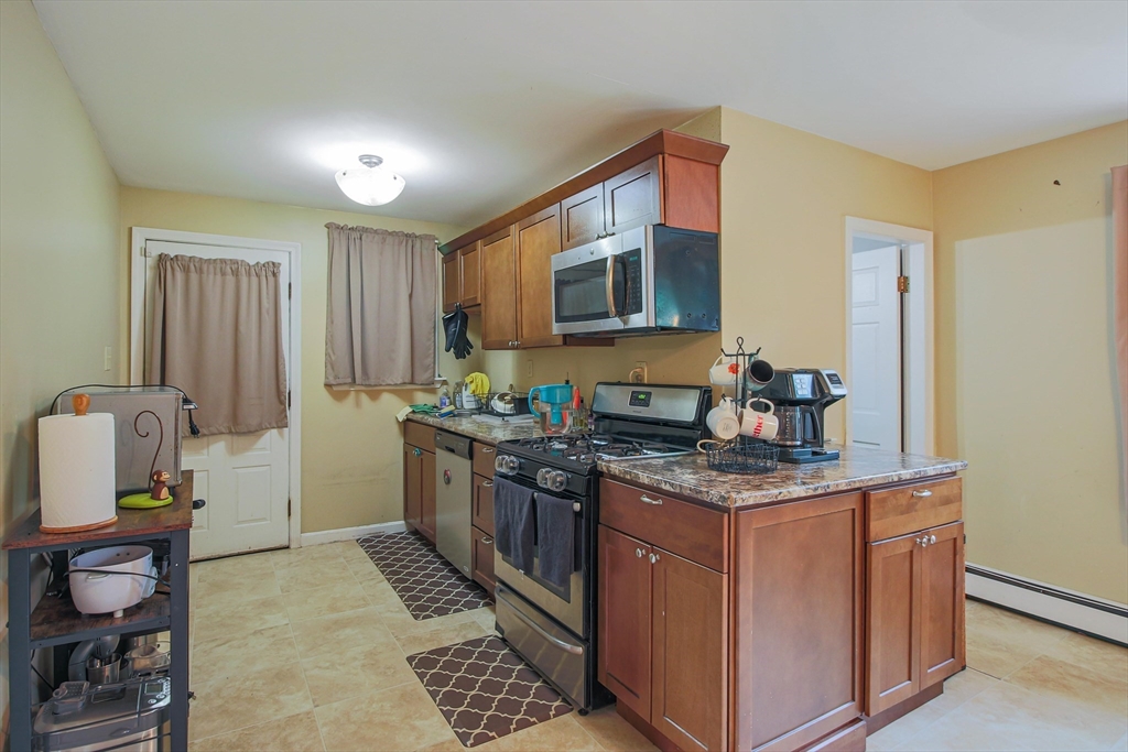 13 Superior Road Worcester, MA 01604 - Photo 25 of 40 a kitchen with stainless steel appliances granite countertop a stove a sink and a refrigerator