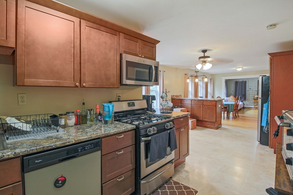 13 Superior Road Worcester, MA 01604 - Photo 26 of 40 a kitchen with stainless steel appliances granite countertop a stove top oven a sink dishwasher and cabinets with wooden floor