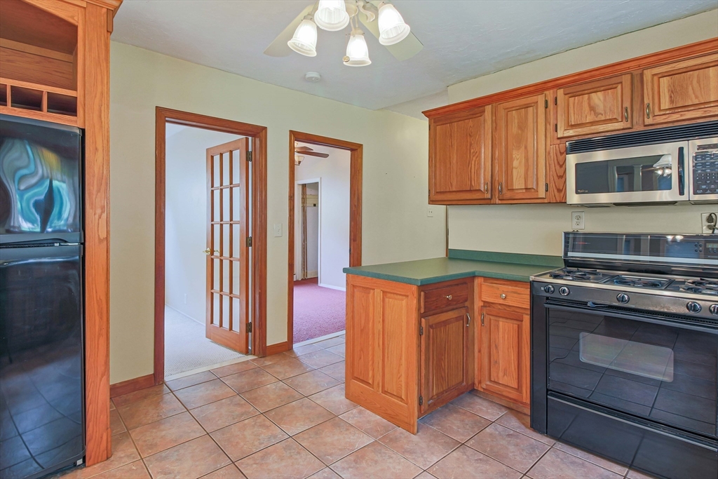13 Superior Road Worcester, MA 01604 - Photo 7 of 40 a kitchen with stainless steel appliances granite countertop a stove and a refrigerator