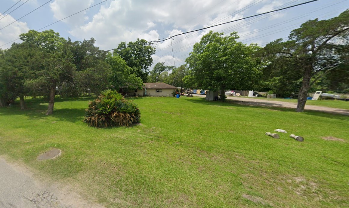 4307 Crosby Cedar Bayou Road Baytown, TX 77521 - Photo 4 of 6 a green field with lots of trees in it