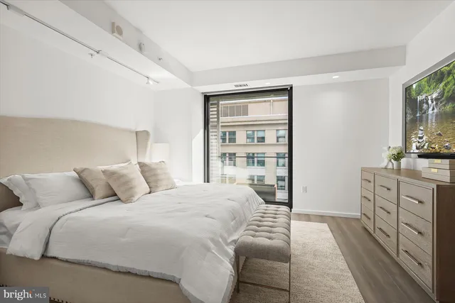 a bedroom with a large bed and a dresser