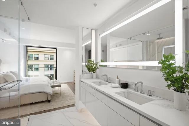 a bedroom with a large bed and potted plant