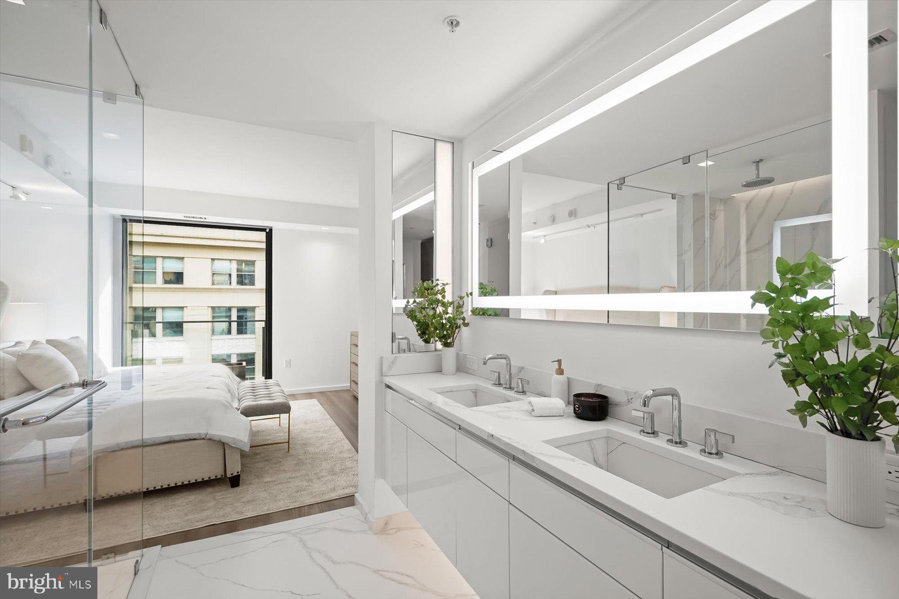 925 H Street Northwest, Unit 901/902 Washington, DC 20001 - Photo 14 of 29 a bedroom with a large bed and potted plant