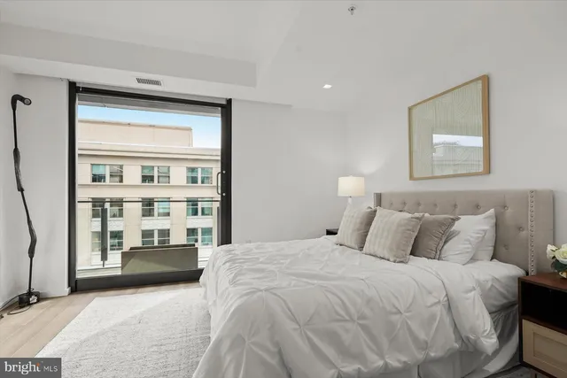 a bedroom with a large bed and a window