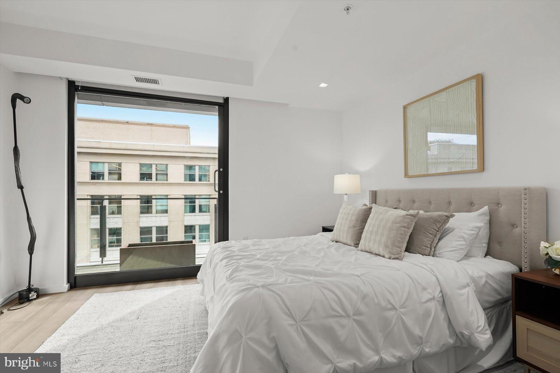 925 H Street Northwest, Unit 901/902 Washington, DC 20001 - Photo 16 of 29 a bedroom with a large bed and a window