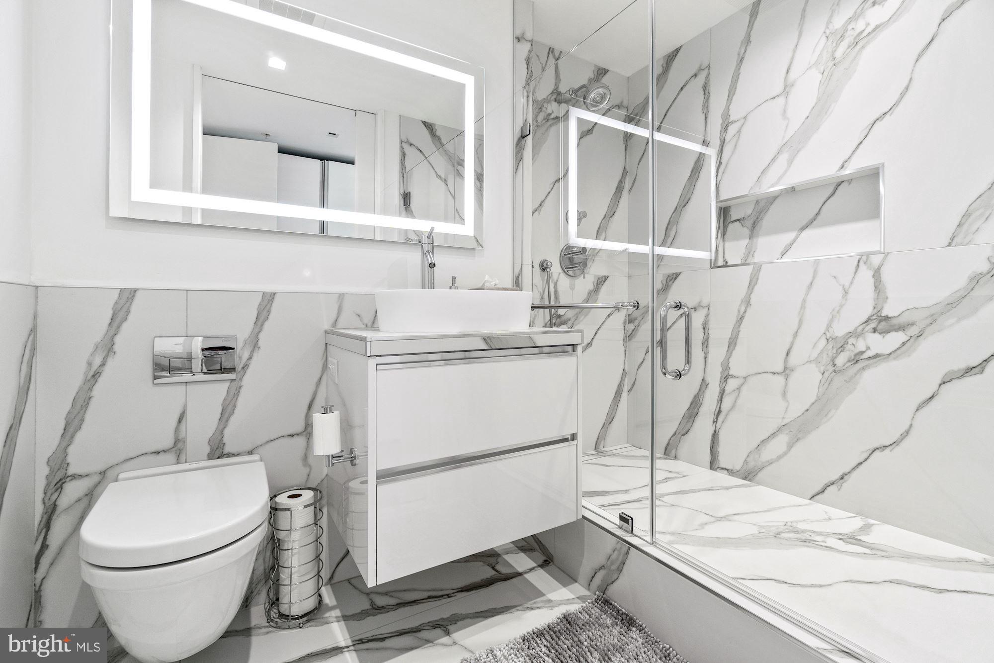 925 H Street Northwest, Unit 901/902 Washington, DC 20001 - Photo 17 of 29 a bathroom with a sink toilet and shower