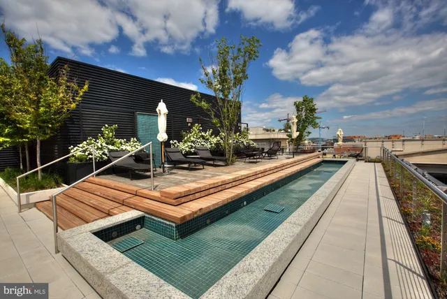 a view of house with pool and outdoor seating