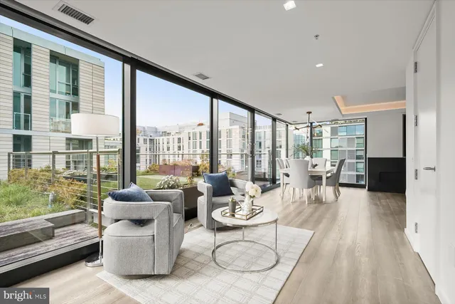 a living room with furniture and a floor to ceiling window