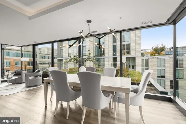 a view of a dining room with furniture large windows and wooden floor